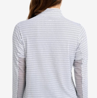 Person wearing a textured white shirt with long sleeves on a plain background
